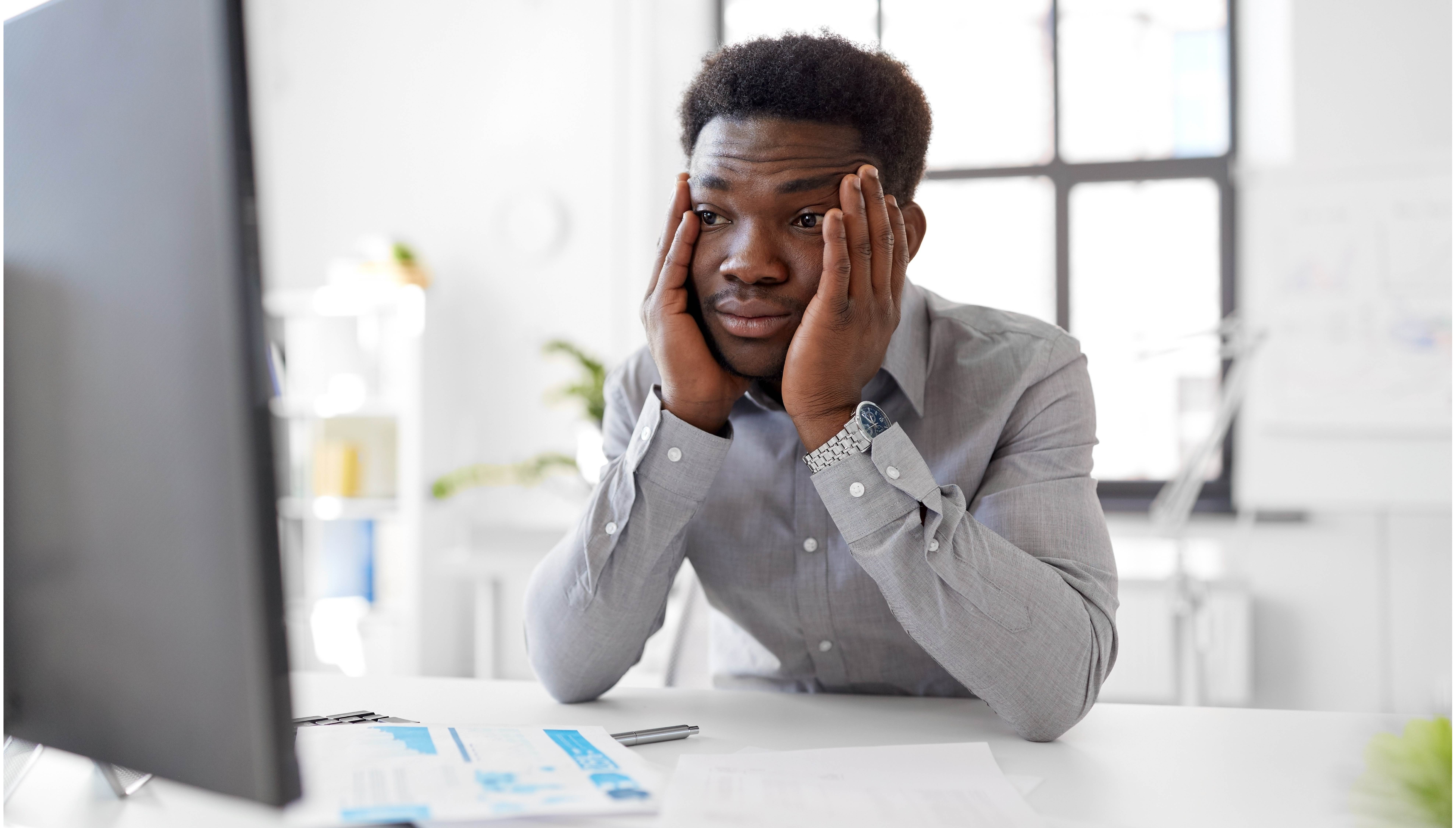 stressed man staring at computer screen